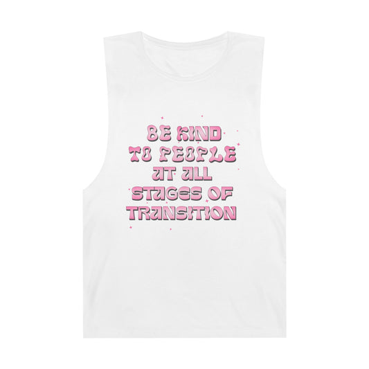 White unisex tank top with pink bubble lettering that says “Be Kind to People at All Stages of Transition”